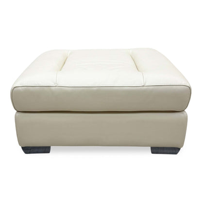 Front-facing view of the Action Taupe leather footstool, highlighting the perfectly flat, uniform surface cushion and crisp, symmetrical tailored perimeter.