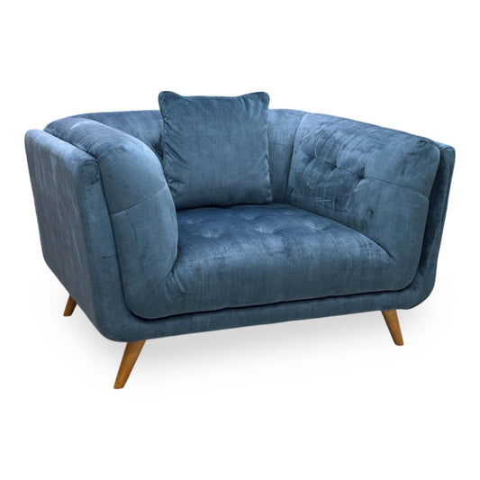 Full view of the Rene cuddler chair in airforce blue fabric, showcasing its oversized design, deep round seating area, and plush matching back scatter cushions.