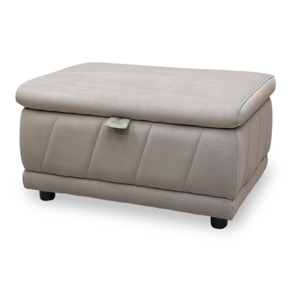 Angle view demonstrating the footstool's uniform height, clean linear proportions, and tightly upholstered base paneling.