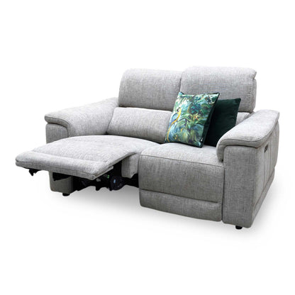 Angle showing one seat fully extended in a relaxing lounging recline with the power headrest lifted and footrest extended.