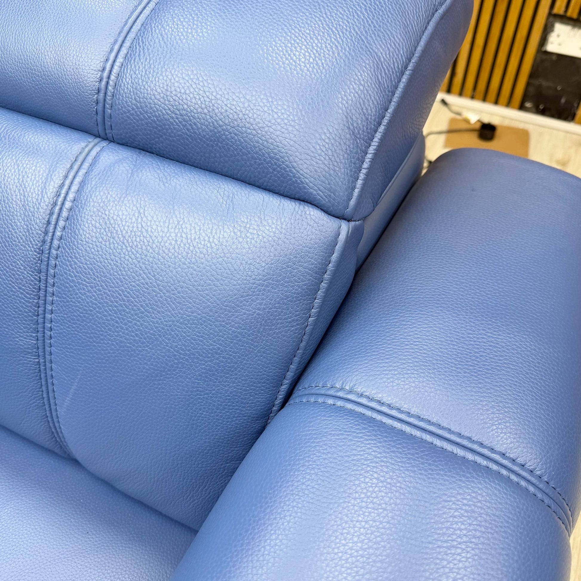High-definition close-up macro view of the Aegean blue leather, showcasing the premium fine-grain texture, supple finish, and rich tonal depth.