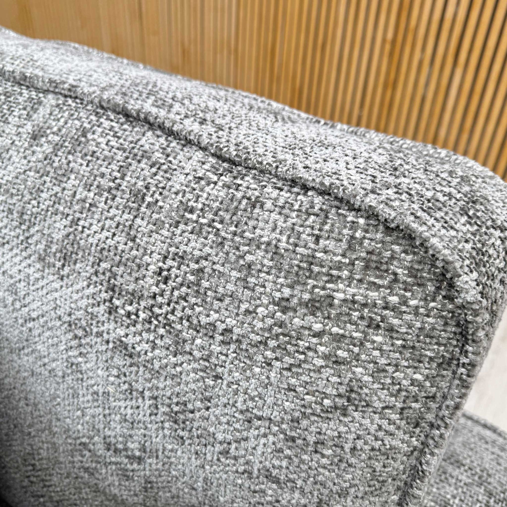 Close-up view of the plush, coordinating accent scatter cushions, highlighting the complementary textured fabric patterns and neutral tones.