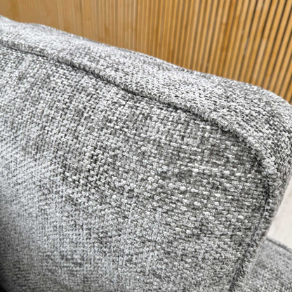 Close-up view of the plush, coordinating accent scatter cushions, highlighting the complementary textured fabric patterns and neutral tones.