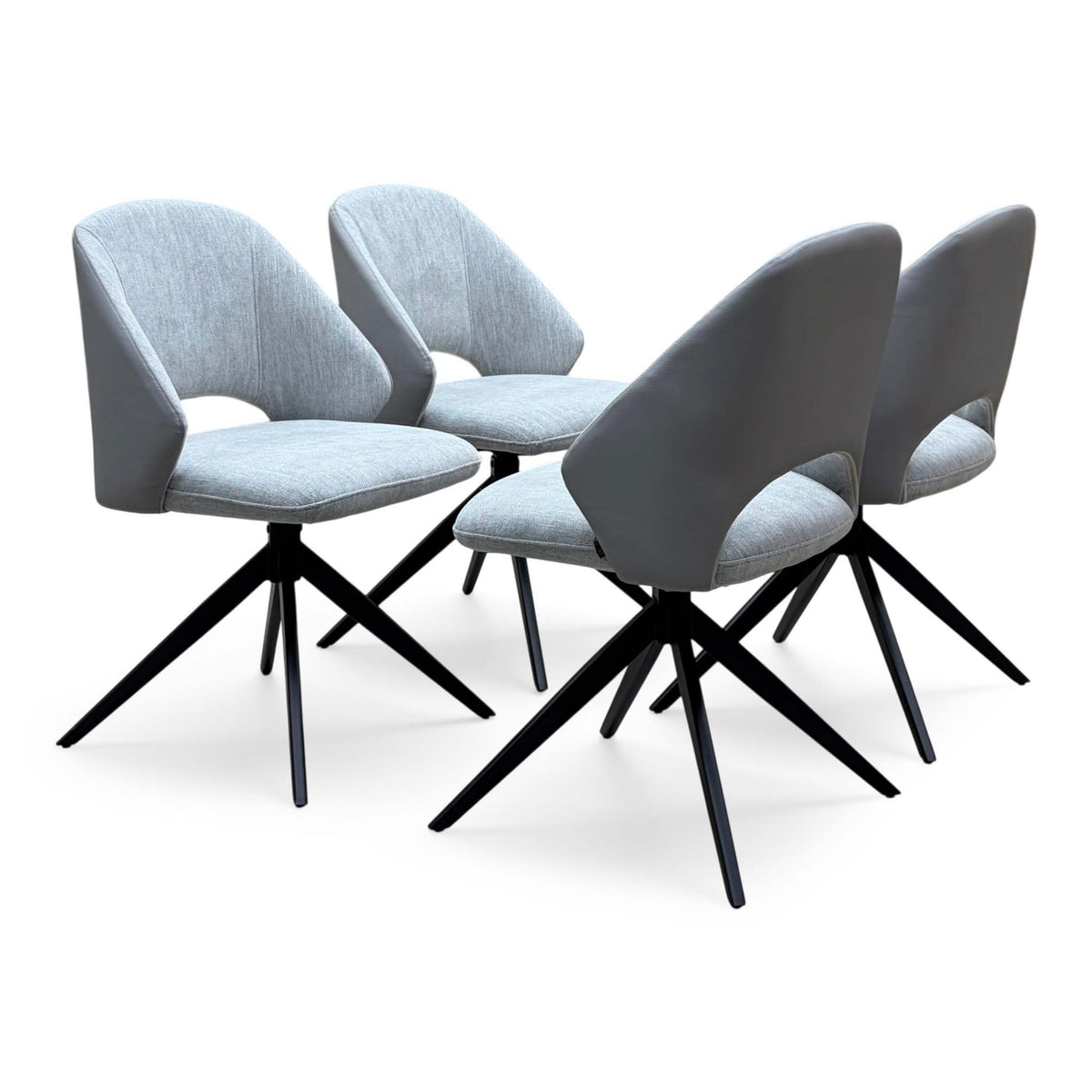 The 4 grey fabric swivel dining chairs from the Raul set, cut-out backs and black star legs