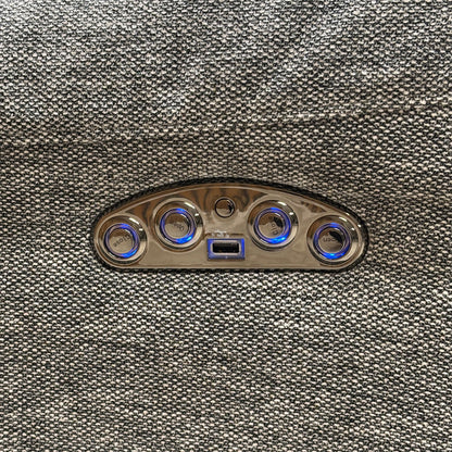 Macro view of the Link SKA-R31 charcoal grey fabric, emphasizing the high-quality woven textile texture, tight seams, and side control panel with an integrated USB charging port.