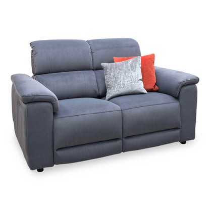 Side view of the Genius fabric power recliner sofa frame, illustrating the supportive armrest cushioning profile and the backrest wall clearance required for a full recline.