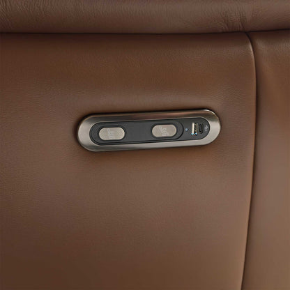 Close-up of the integrated metallic control panel on the side of the Bobby sofa, showing the smooth power reclining buttons and built-in USB charging port.