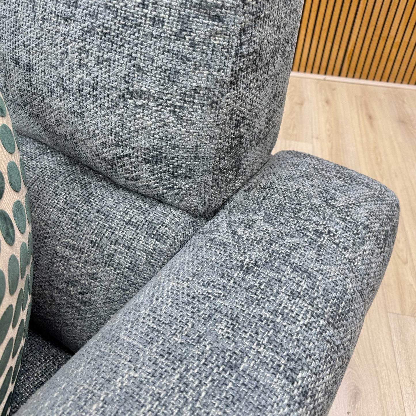 Close up view of the New York 2-seater sofa, displaying the clean, fully upholstered silverish blue fabric back panels and neat power cable management layout.