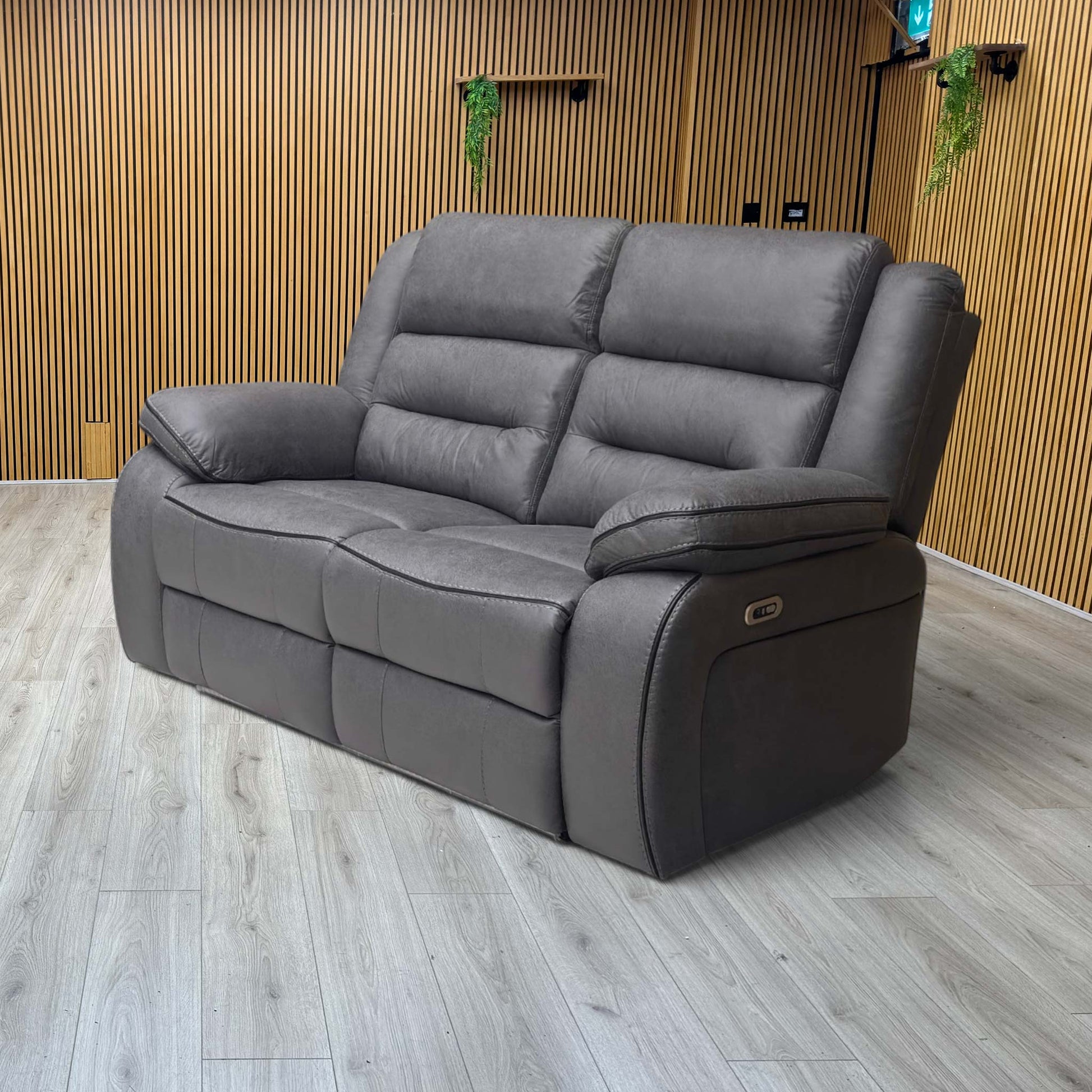 Lifestyle view Vegas charcoal grey microfibre power recliner sofa with both seats fully extended. Image showcases the dual-motor independent electronic footrests and reclining backrests, illustrating a seamless transition into full lounge position.