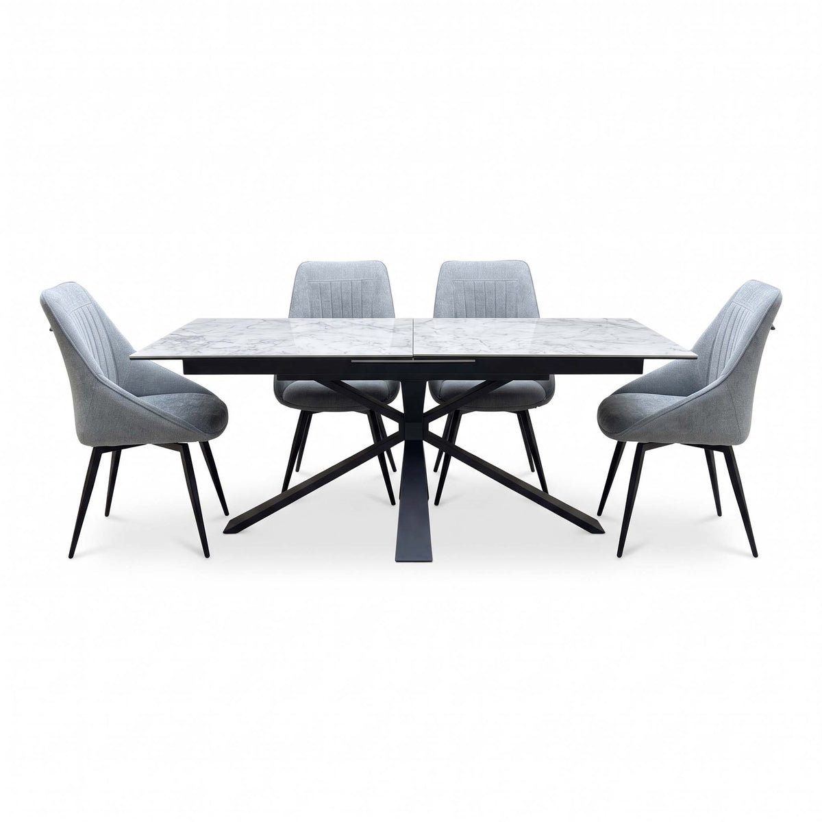 Front view of the Crete ceramic top extending dining table with four dark grey fabric swivel chairs