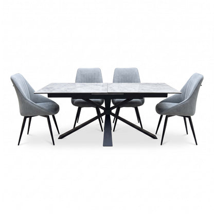 Front view of the Crete ceramic top extending dining table with four dark grey fabric swivel chairs