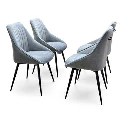 The four dark grey fabric swivel chairs from the Crete dining set, angled from the left on black legs