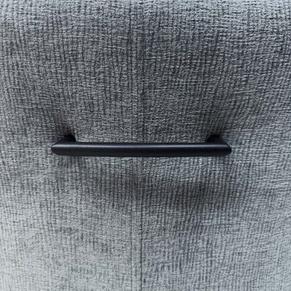 Close-up of the black metal grab handle on the back of a Crete dark grey fabric swivel dining chair