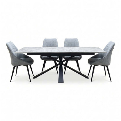Crete ceramic top extending dining table set with four dark grey swivel chairs, straight-on view on white