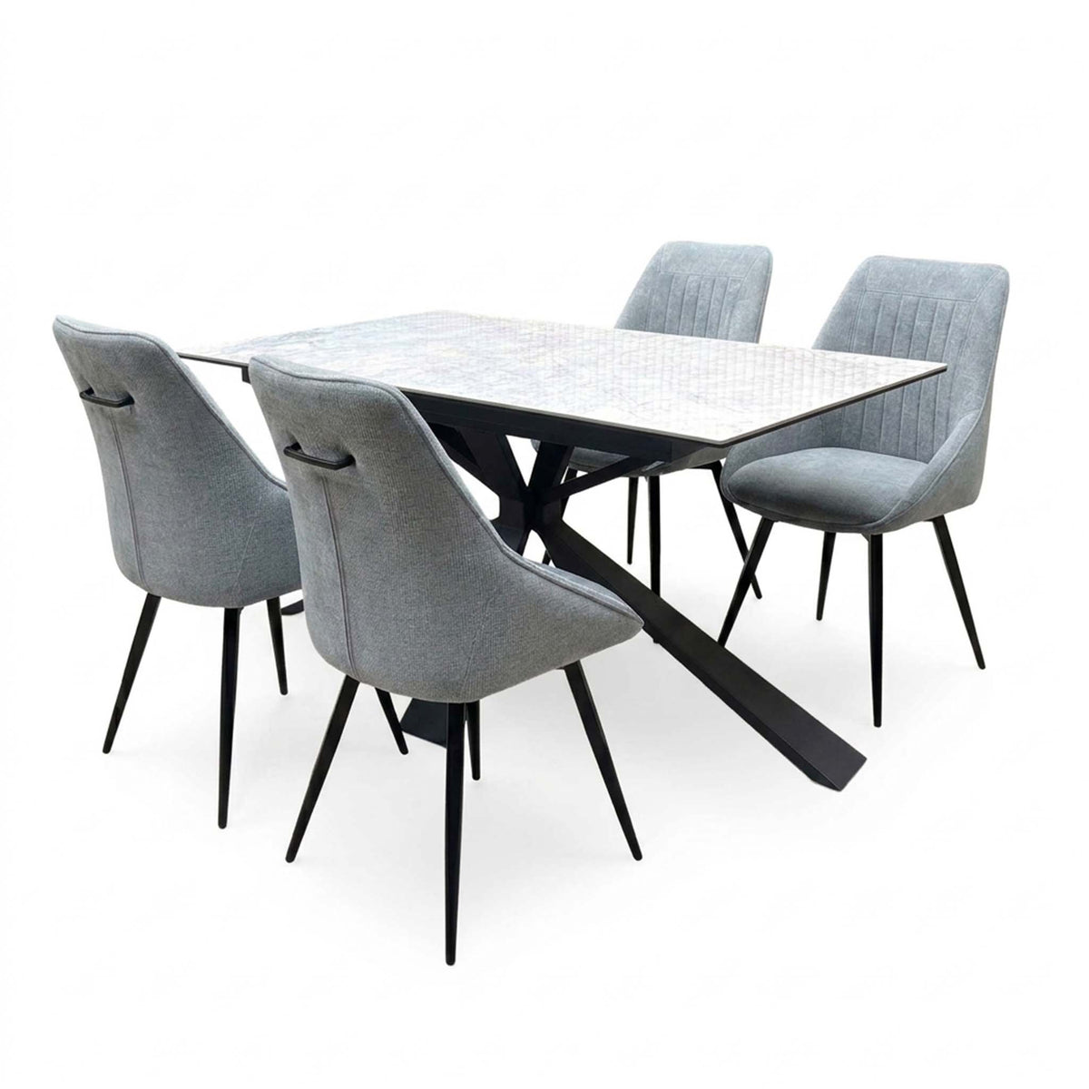 Crete ceramic top 180cm extending dining table with four dark grey fabric swivel chairs, angled from the left