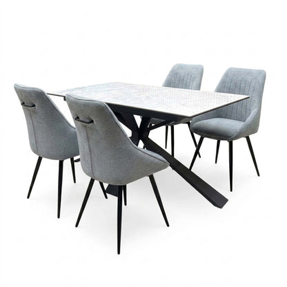 Crete ceramic top 180cm extending dining table with four dark grey fabric swivel chairs, angled from the left