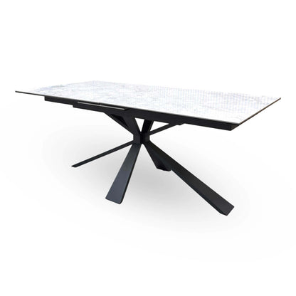 Crete ceramic top extending dining table on its own, raised angle showing the marble-effect top seam