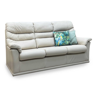 Beige sofa with decorative pillows on a white background