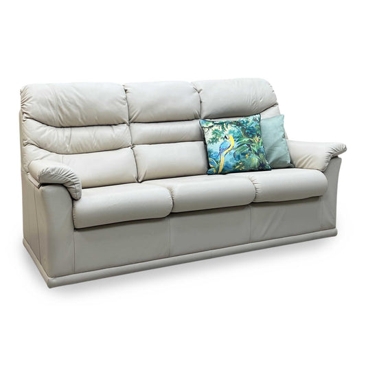 Beige sofa with decorative pillows on a white background
