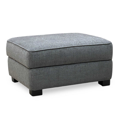 Gray upholstered ottoman on a white background