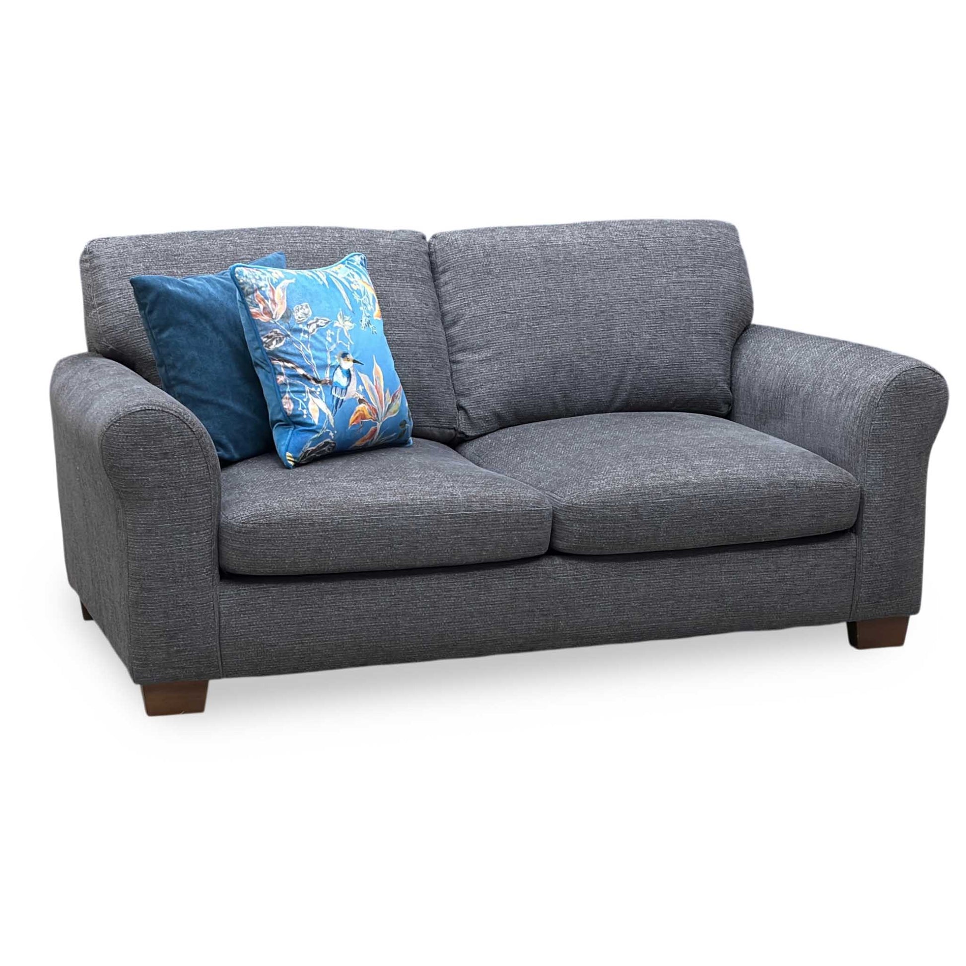Gray sofa with blue and floral-patterned cushions on a white background