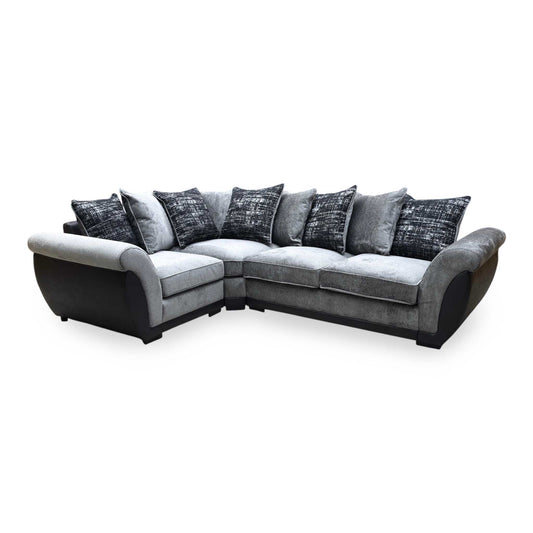 Gray corner sofa with patterned cushions on a white background