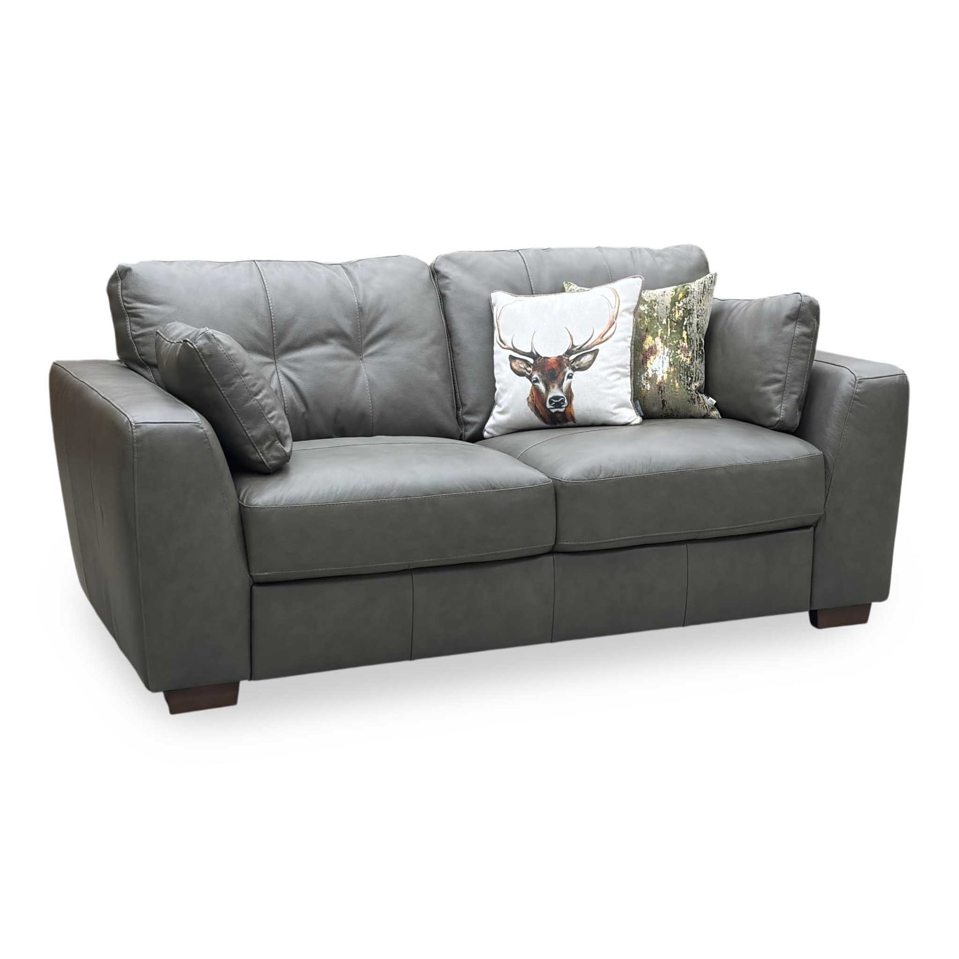 Gray leather sofa with decorative pillows on a white background