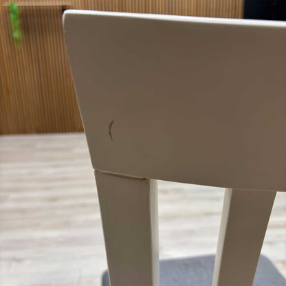 Close-up view from a high angle looking down at the seat and backrest junction, displaying the flawless edge finishing, tight tolerances, and pristine tailored construction lines.Damage on chair.