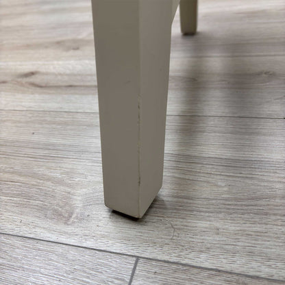 Close-up view from a high angle looking down at the seat and backrest junction, displaying the flawless edge finishing, tight tolerances, and pristine tailored construction lines.Damage on chair Legs.