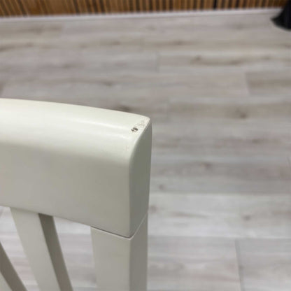 Close-up view from a high angle looking down at the seat and backrest junction, displaying the flawless edge finishing, tight tolerances, and pristine tailored construction lines.Damage on chair.