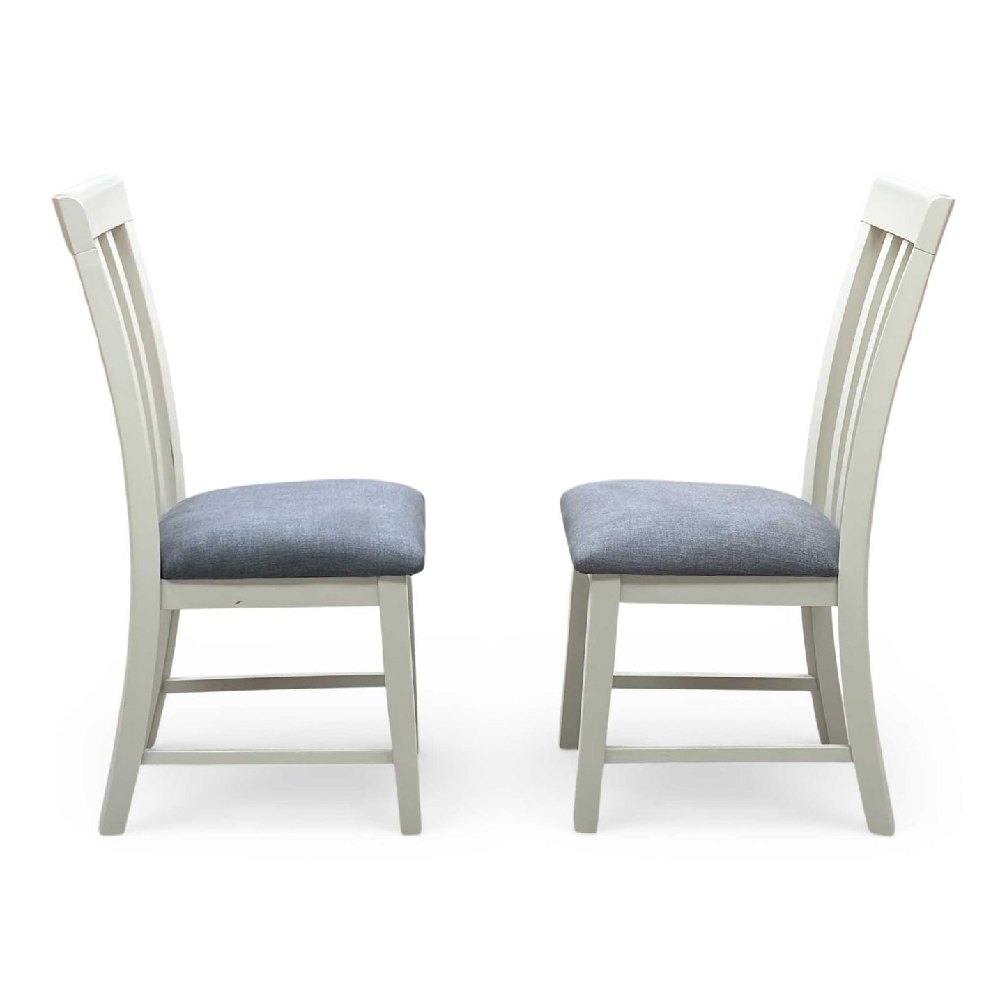 Front-facing view of the two Hamilton high-back wooden dining chairs arranged side-by-side, highlighting the uniform vertical alignment, slim profiles, and modern geometric styling.