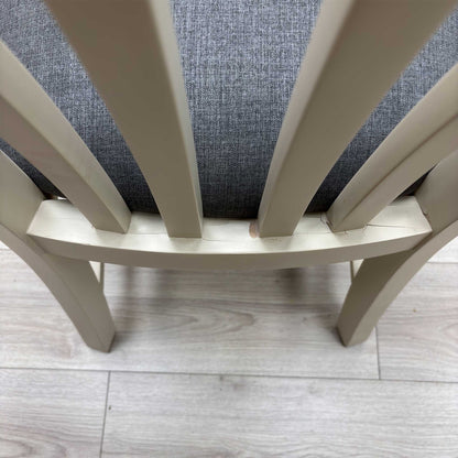 Close-up view from a high angle looking down at the seat and backrest junction, displaying the flawless edge finishing, tight tolerances, and pristine tailored construction lines.Damage on chair.