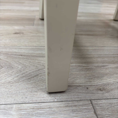 Close-up view from a high angle looking down at the seat and backrest junction, displaying the flawless edge finishing, tight tolerances, and pristine tailored construction lines.Damage on chair leg.