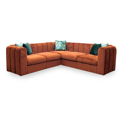 Brown sectional sofa with decorative pillows on a white background