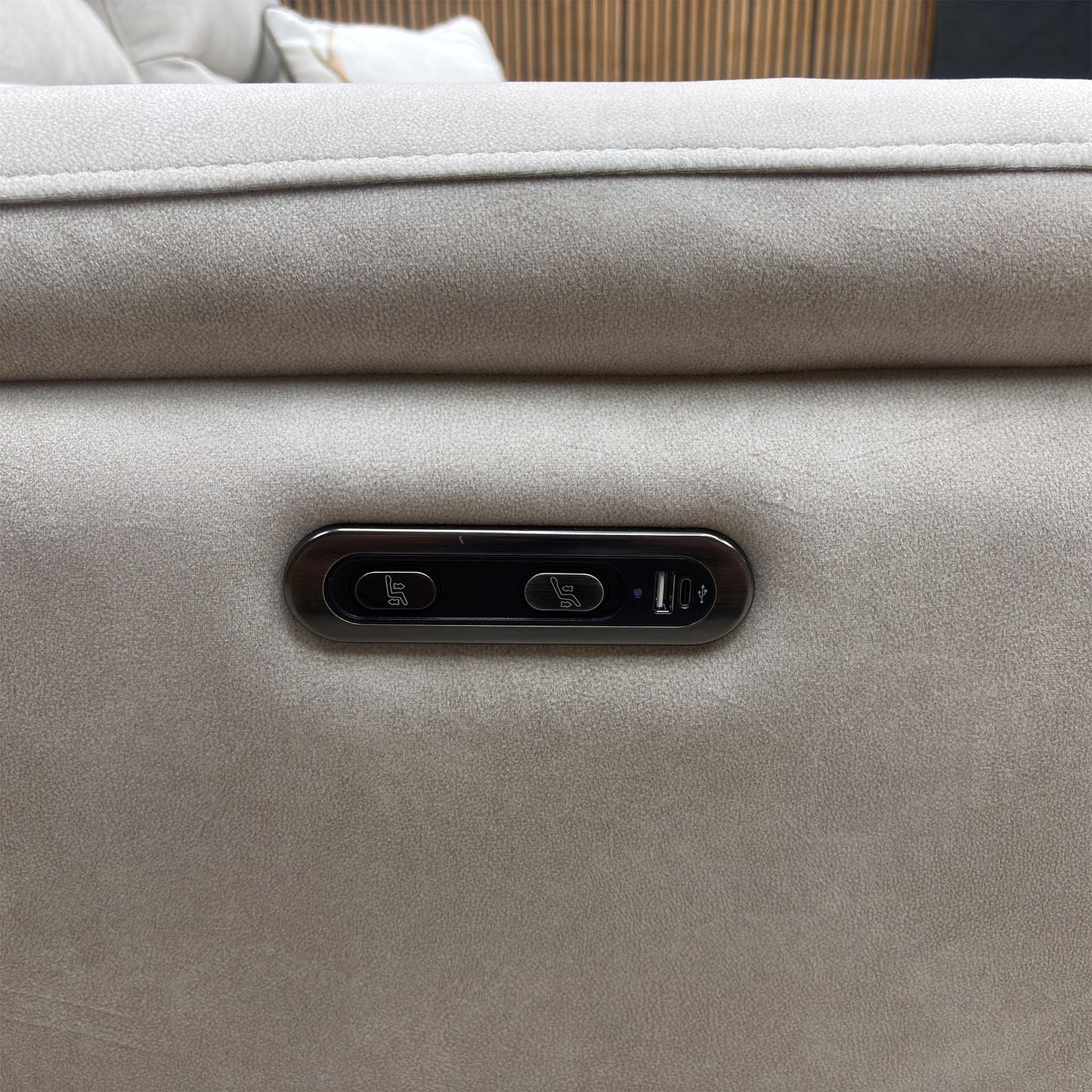 Close-up view of the outer armrest detailing the integrated power adjustment buttons for seamless reclining operation along with a convenient built-in USB charging port.