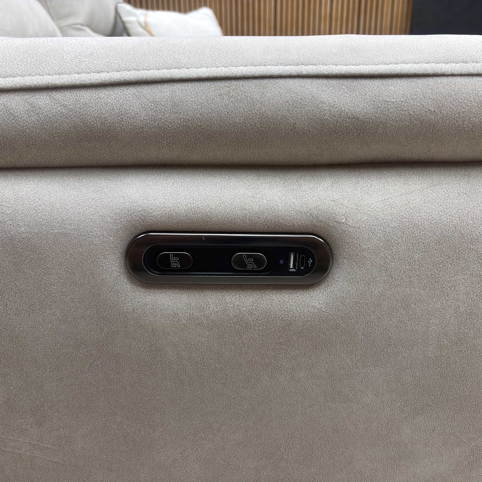 Close-up view of the outer armrest detailing the integrated power adjustment buttons for seamless reclining operation along with a convenient built-in USB charging port.