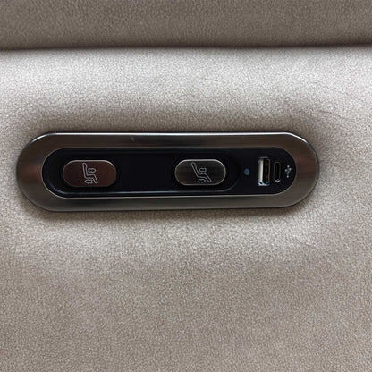 Close-up view of the outer armrest detailing the integrated power adjustment buttons for seamless reclining operation along with a convenient built-in USB charging port.