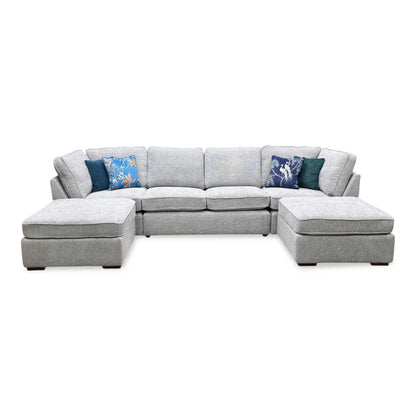 Front-facing view of the sprawling U-shaped corner sofa suite, highlighting the massive dual-chaise symmetrical layout, deep multi-cushion seating configurations, and clean lines.