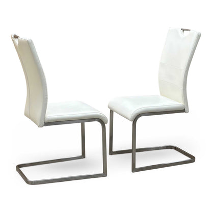 Full View ‘Bianco’ contemporary dining chair set, showcasing a pair of sleek chairs beautifully upholstered in crisp White faux leather supported by minimalist chrome cantilever bases.