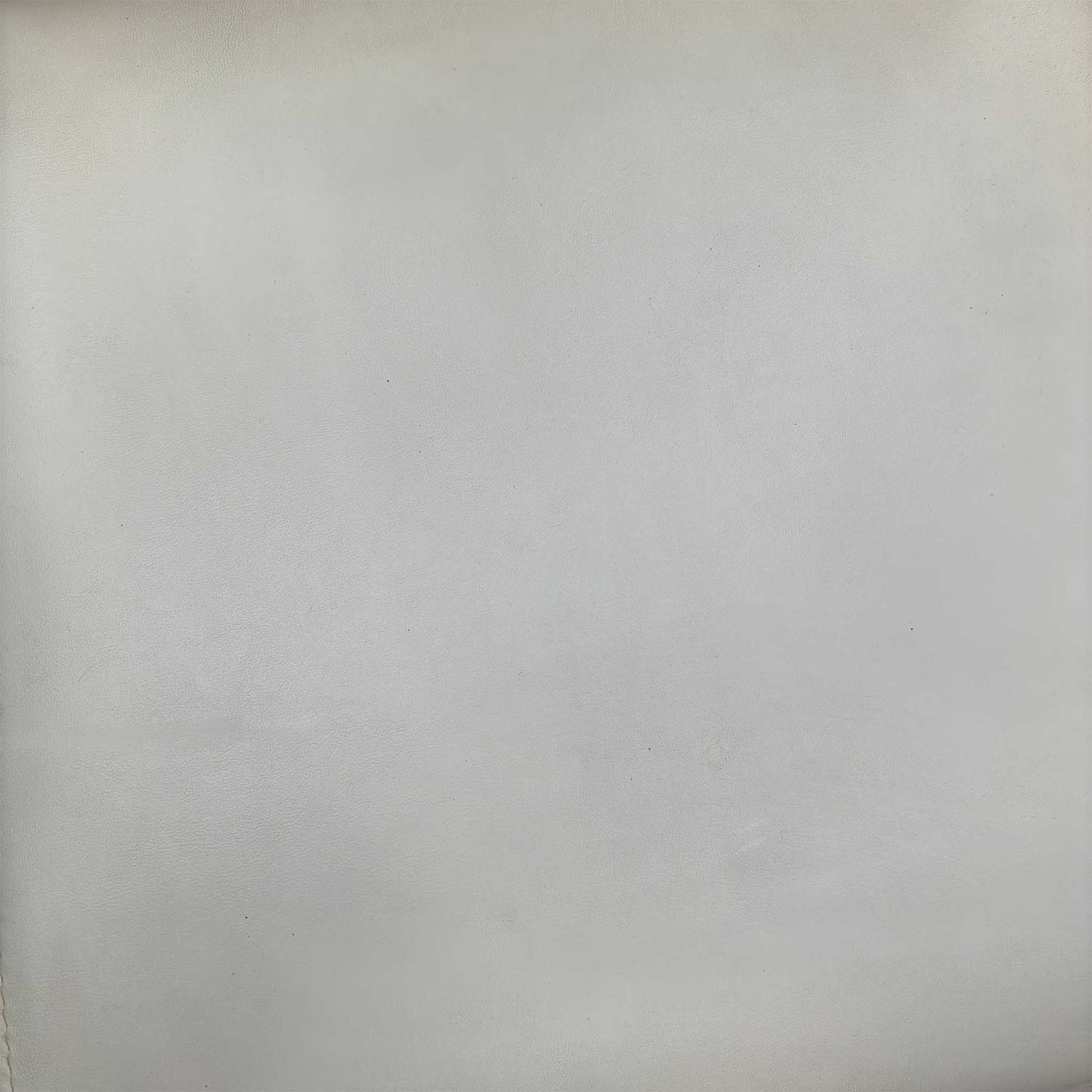 High-definition close-up macro view of the Bianco White faux leather upholstery, detailing the premium fine-grain surface texture, pristine matte finish, and clean modern tailoring lines.