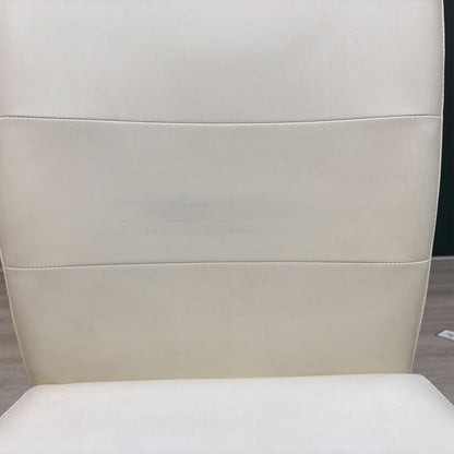 Close-up view from a high angle looking down at the seat cushion, displaying the flawless fabric tensioning across the padded surface, tight corner seams, and precise perimeter stitching.Small defect on the chair.