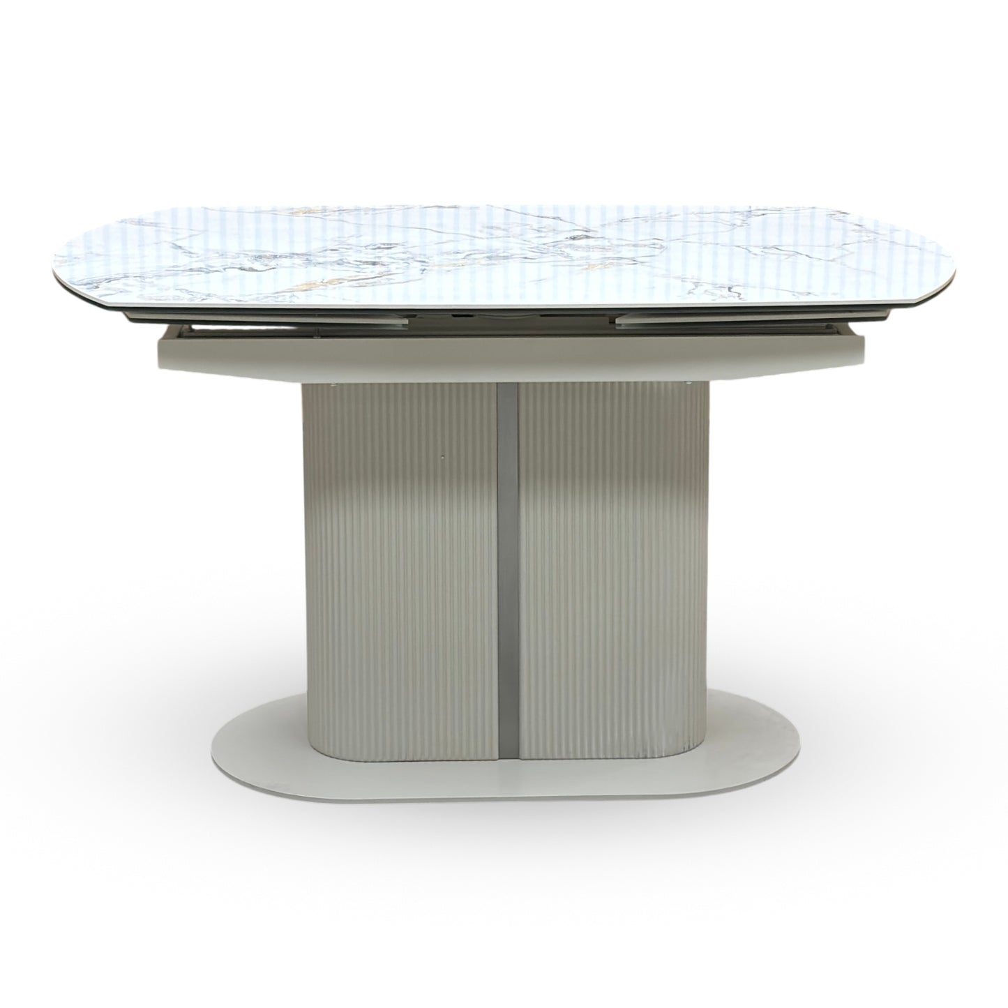 Avorio ivory ceramic dining table shown fully extended. Displays the unique rotating swivel top action that smoothly pivots to reveal integrated extensions, expanding the surface area for additional dining seating.