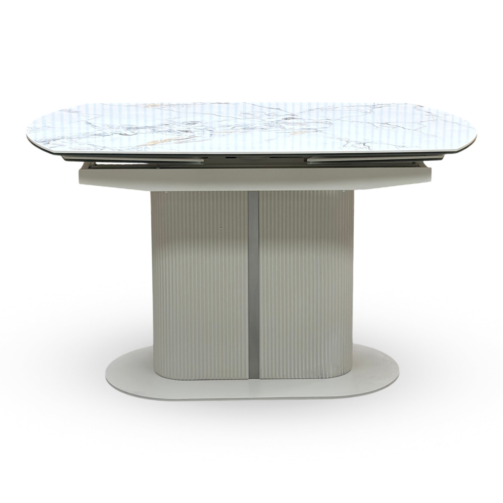 Avorio ivory ceramic dining table shown fully extended. Displays the unique rotating swivel top action that smoothly pivots to reveal integrated extensions, expanding the surface area for additional dining seating.