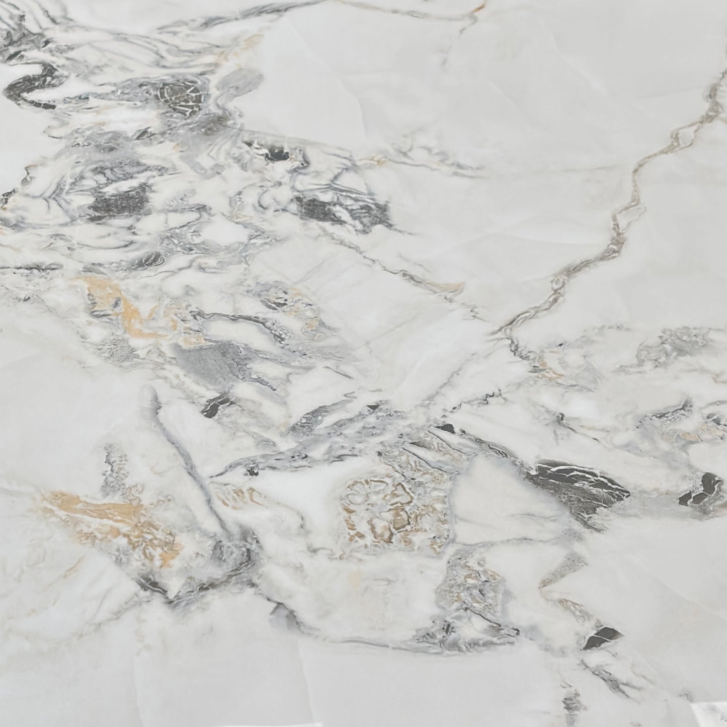 Close-up macro detail of the Avorio ceramic table top surface. Showcases the premium scratch-resistant white tile finish, delicate grey and gold marble effect veining, and heat-proof engineered layer structure.