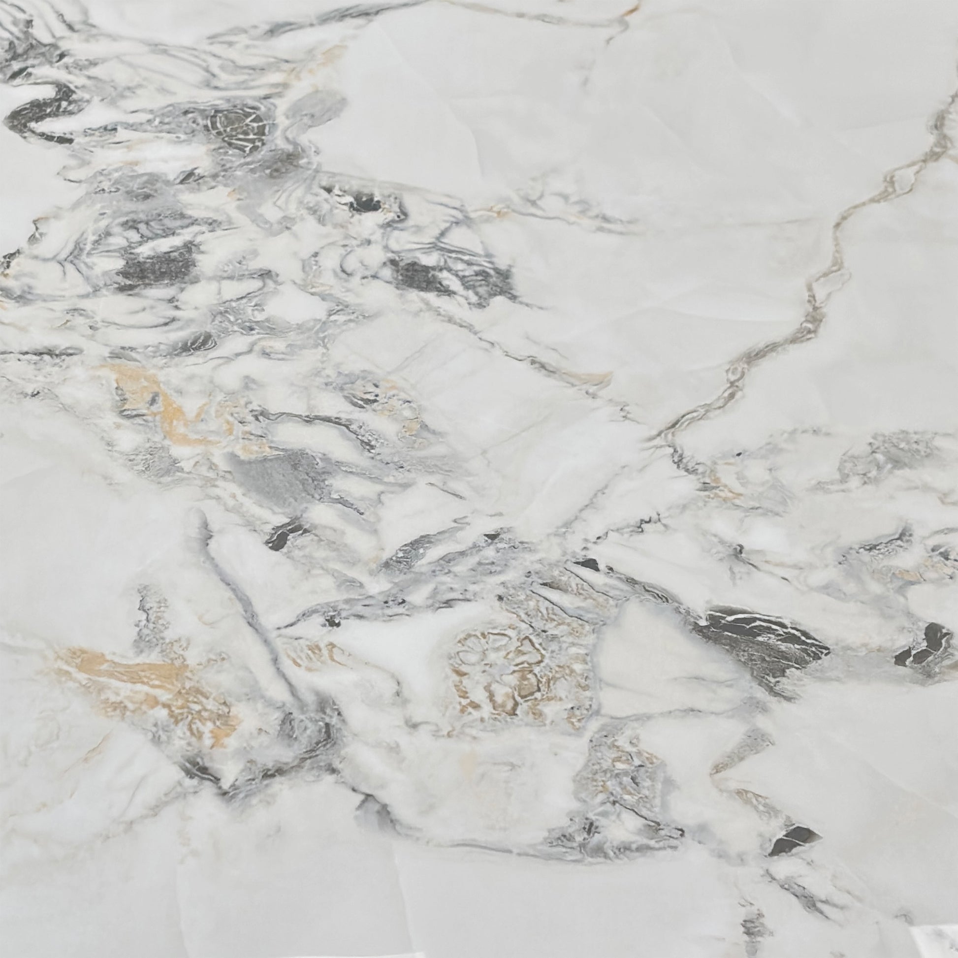 Close-up macro detail of the Avorio ceramic table top surface. Showcases the premium scratch-resistant white tile finish, delicate grey and gold marble effect veining, and heat-proof engineered layer structure.