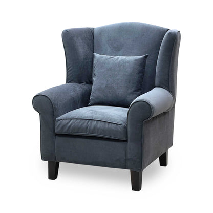 Side perspective profile view of the wing chair, demonstrating the classic ergonomic tilt of the backrest, clean scroll arm detailing, and pristine fabric tensioning.
