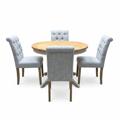 ‘Lewis’ Natural Oak Round Pedestal Butterfly Extending Dining Table with Mist Grey Fabric Button Back Dining Chairs - Set of 4 Furniture Village