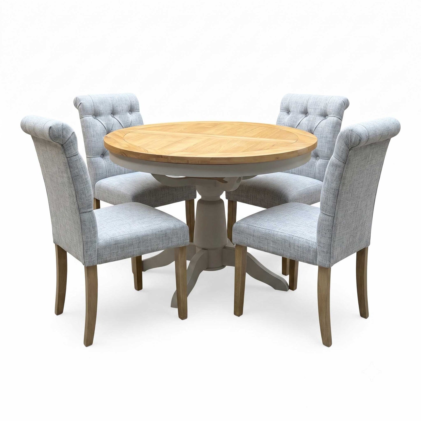 ‘Lewis’ Natural Oak Round Pedestal Butterfly Extending Dining Table with Mist Grey Fabric Button Back Dining Chairs - Set of 4 Furniture Village