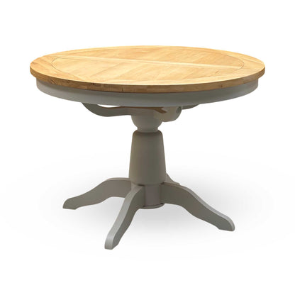 ‘Lewis’ Natural Oak Round Pedestal Butterfly Extending Dining Table with Mist Grey Fabric Button Back Dining Chairs - Set of 4 Furniture Village
