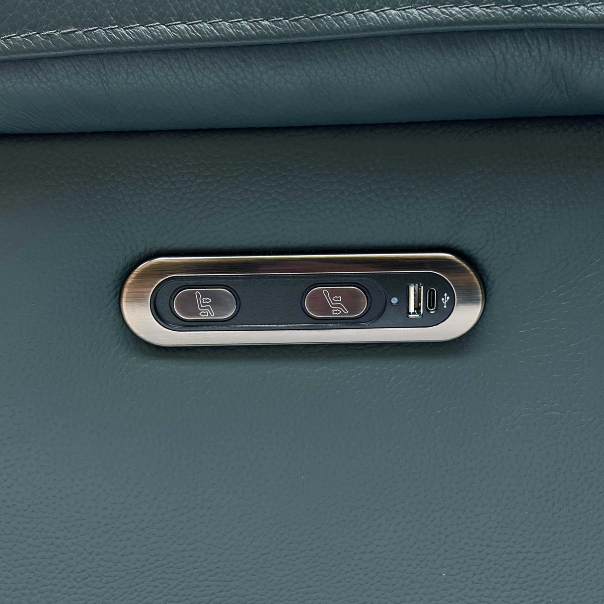 Close-up of the power recline buttons and USB port on the Raven peacock green leather power chair
